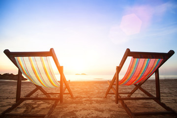 Beach chairs on the evening sea coast.