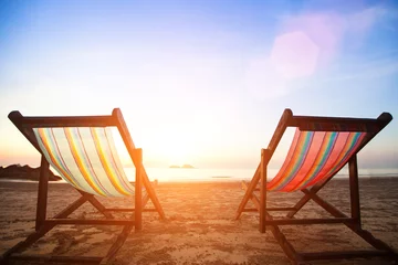 Foto op Plexiglas Kust Beach chairs on the evening sea coast.