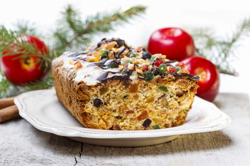 Fruitcake with dried fruits and nuts in christmas setting