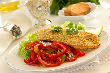Fried cod fillet with sweet and sour peppers.