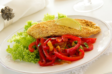 Fried cod fillet with sweet and sour peppers.