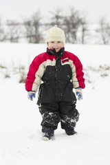 Fototapeta na wymiar Young kid makes winter fun with sledge outdoor