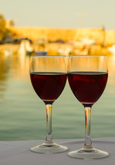 Red wine glasses with sea view in the autumn