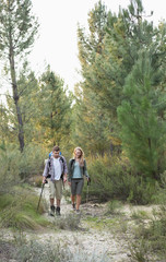 Full length of a fit couple exploring the woods