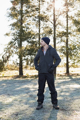 Man in warm clothing while having a walk in forest on a winter d