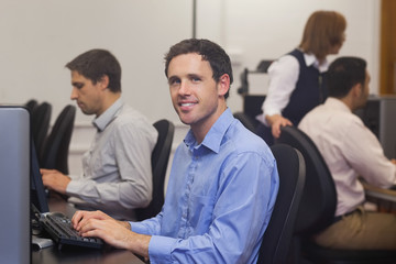 Obraz premium Attractive male student sitting in computer class