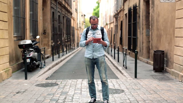 Man looking for direction on map in tablet computer