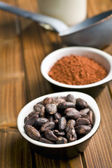 cocoa beans and cocoa powder in bowls
