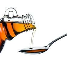 maple syrup pouring on spoon