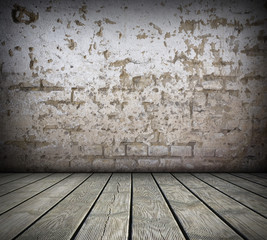 Room with damaged brick wall