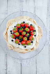 Pavlova Cake with strawberry and blueberries closeup
