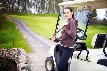 Fototapeta na wymiar Woman standing near golf cart car