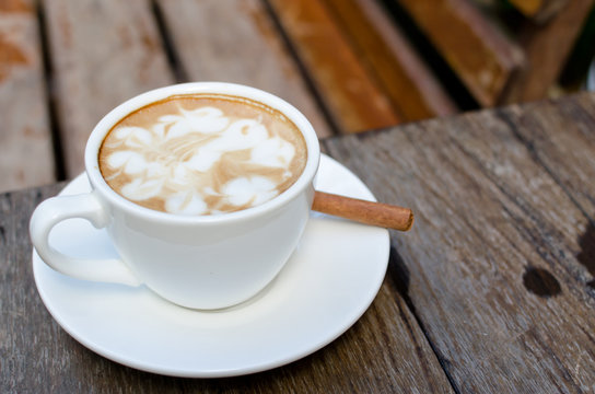 A cup of hot latte with cinnamon