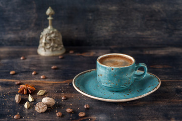 Сup of espresso coffee with spices on a vintage background
