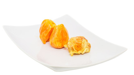 Fresh and fried chempedak arils in a white plate.