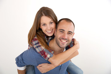 Man giving piggyback ride to girlfriend