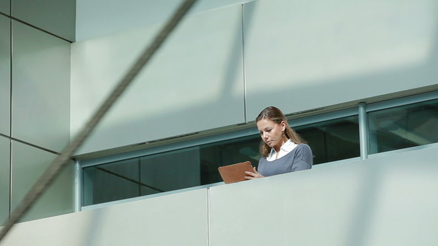 business woman with tablet computer in office building
