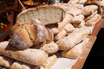 A Market Stall Selling a Variety of Bread Loaves.