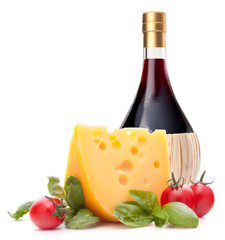Red wine bottle, cheese and tomato still life
