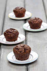 Chocolate muffins before decorating on wooden table