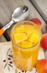 Orange drink on wooden table, selective focus