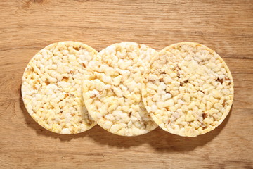 Thin round corn cakes on wooden background