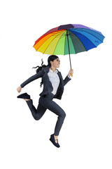 Happy businesswoman jumping with umbrella