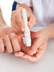 Doctor Checking Sugar Level Of Patient