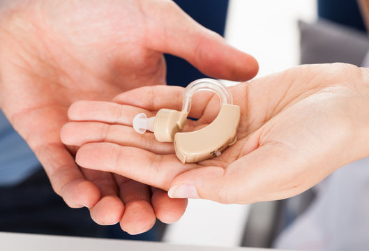 Hand Holding Hearing Aid