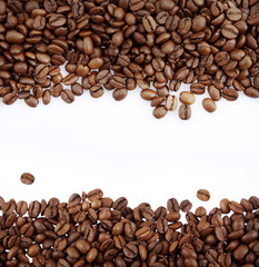 Roasted coffee beans on white background. Copy space