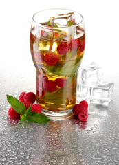 Iced tea with raspberries and mint isolated on white