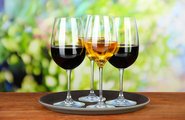Glasses of wine, on bright background