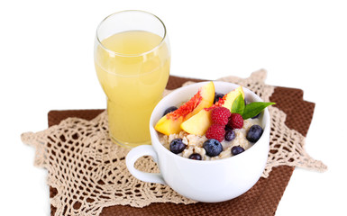 Oatmeal in cup with berries on napkins isolated on white