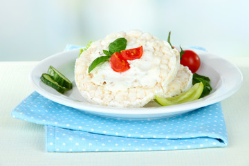 Tasty crispbreads with vegetables on white table