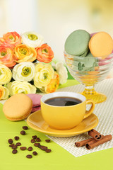 Coffee and macaroons on table on light background