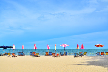 Chairs and umbellar on white sand beach.