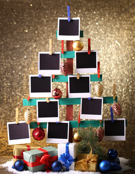 Wooden hand made fir tree with empty photo paper and Christmas