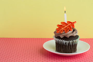 Cupcake on a Saucer with a Candle