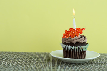 Cupcake on a Saucer with a Candle