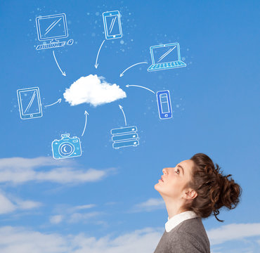 Casual girl looking at cloud computing concept on blue sky