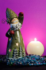 Santa Claus and Burning Candle on Magenta Background