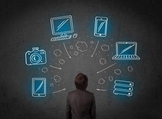 Businessman with multimedia icons over his head
