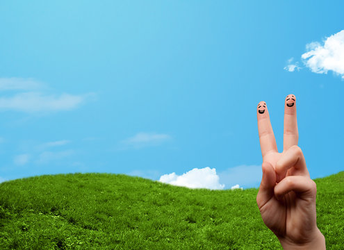 Cheerful finger smileys with landscape scenery at the background