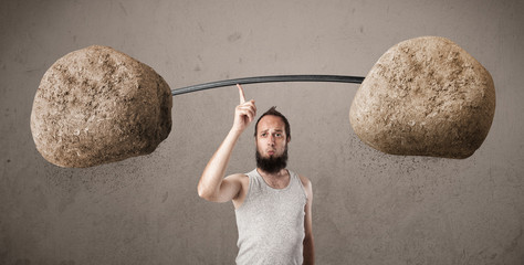 skinny guy lifting large rock stone weights