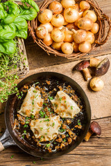 Homemade dumplings with mushrooms fried with onion and parsley