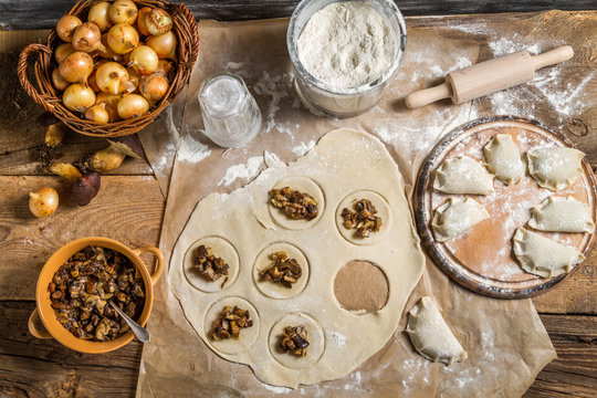 Homemade dumplings with onion and wild mushrooms