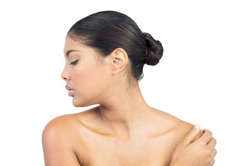 Calm nude brunette turning head