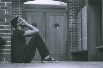 Unhappy handsome student in pain having a headache