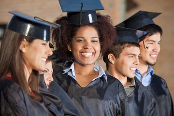 Woman With Friends On Graduation Day At College