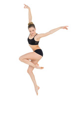 Fototapeta na wymiar Elegant slim ballet dancer jumping in the air